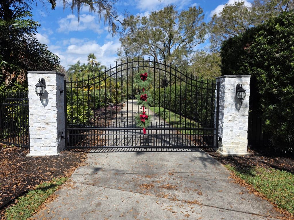 Arched Gate with Lantern Pillars installed by KSM Gates in the Tampa Bay area