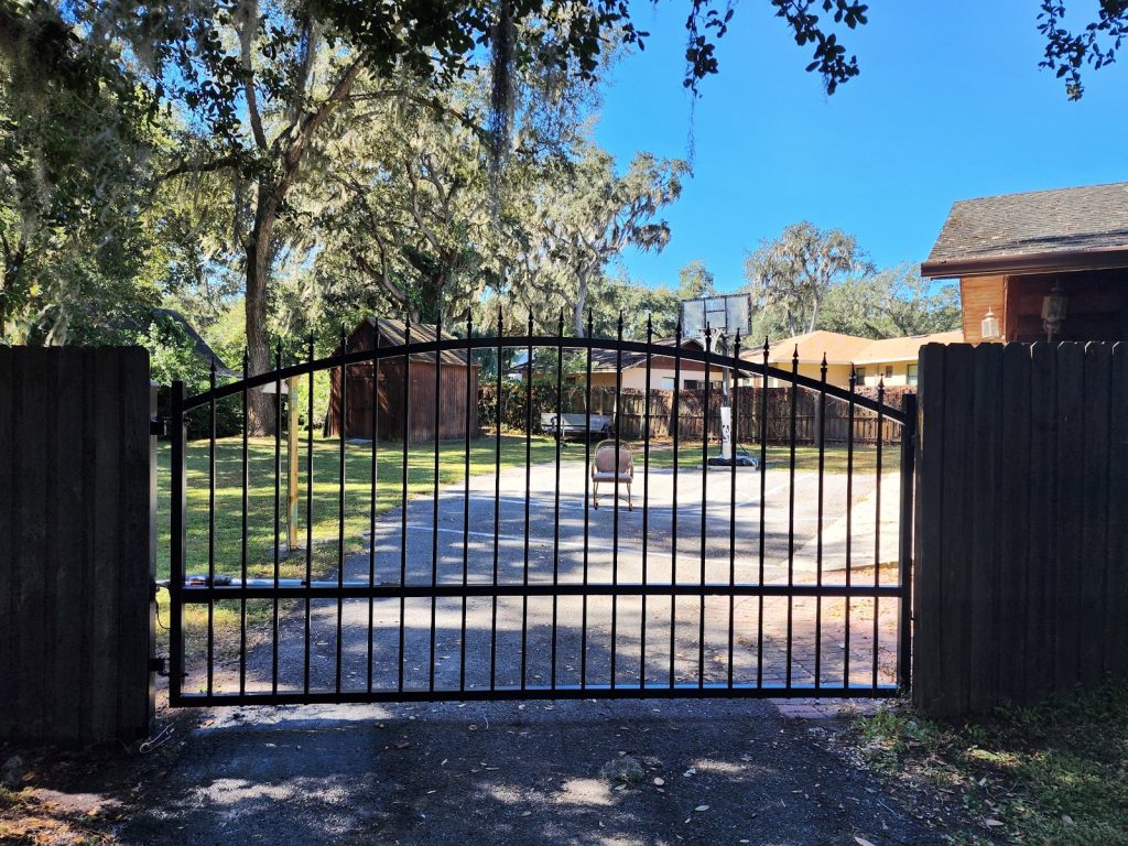Arched Gate with Wood Privacy Surround installed by KSM Gates in the Tampa Bay area