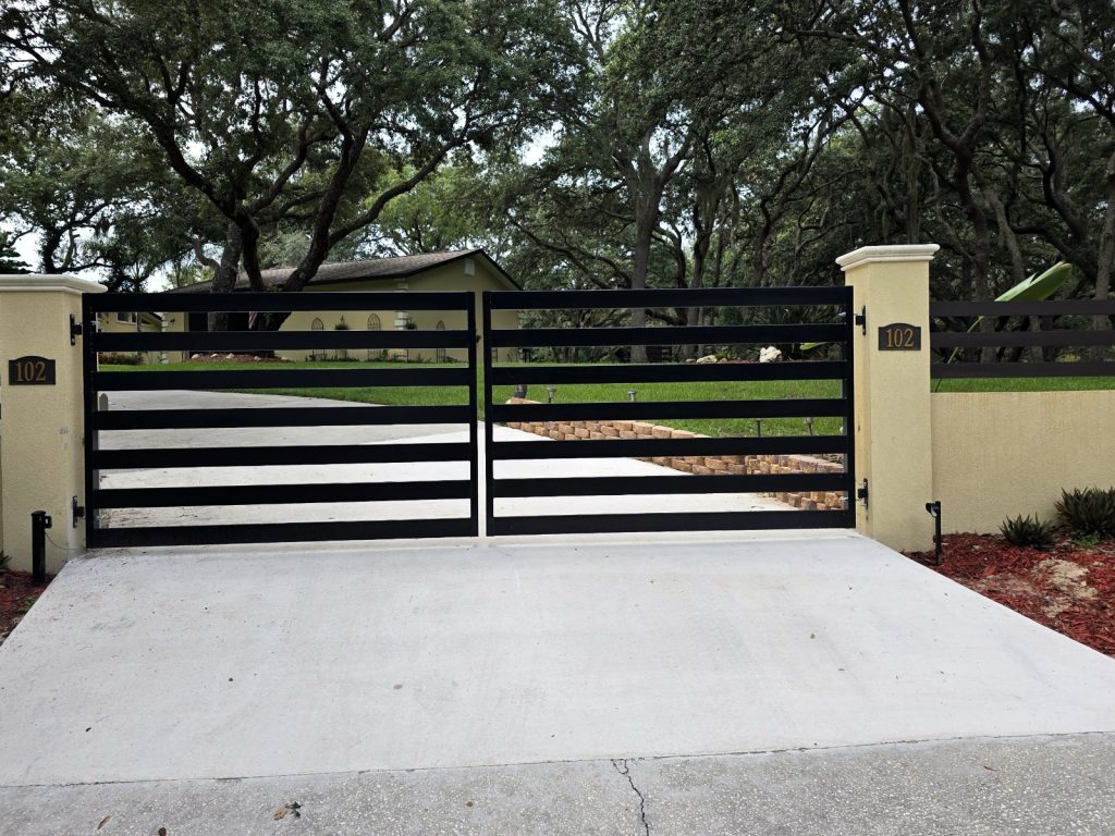 Horizontal Slat Gate with Stucco Pillars installed by KSM Gates in the Tampa Bay area