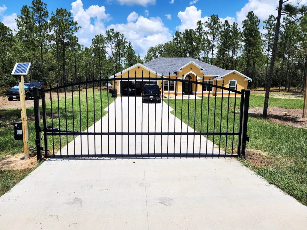 Solar-Powered Arched Driveway Gate installed by KSM Gates in the Tampa Bay area