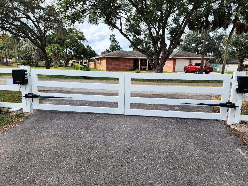White 3-Rail Automatic Dual Gate installed by KSM Gates in the Tampa Bay area
